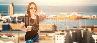 Composite image of smiling model holding disposable coffee cup