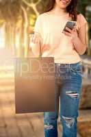 Composite image of women holding bag with blank space