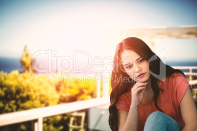Composite image of thoughtful young woman relaxing on tiled floor