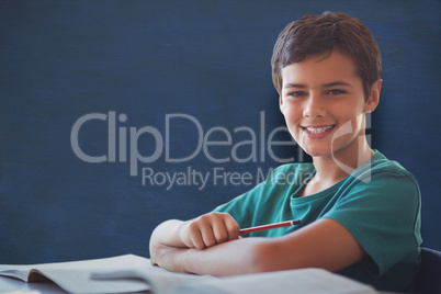 Composite image of portrait of boy doing homework Composite image of portrait of boy doing homework