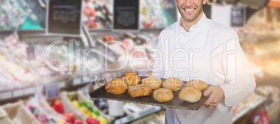 Composite image of baker showing bread against white background