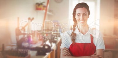 Composite image of portrait of confident female owner with arms crossed