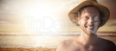 Composite image of handsome man wearing hat