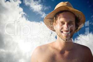 Composite image of handsome man wearing hat