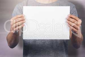 Composite image of midsection of man holding cardboard