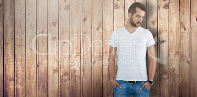 Composite image of thoughtful male model with hands in pockets