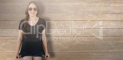 Composite image of smiling model wearing sunglasses stretching top