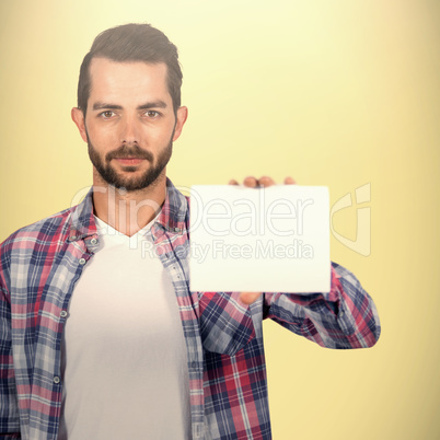 Composite image of portrait of young man shoowing placard