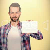 Composite image of portrait of young man shoowing placard