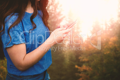 Composite image of women touching her phone