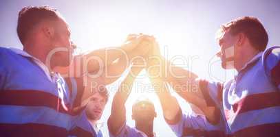 Low angle view of rugby team stacking hands