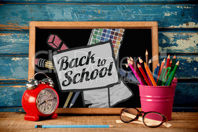 Composite image of back to school text on paper with pen