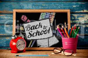 Composite image of back to school text on paper with pen