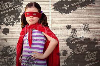 Composite image of portrait of girl standing in superhero costume