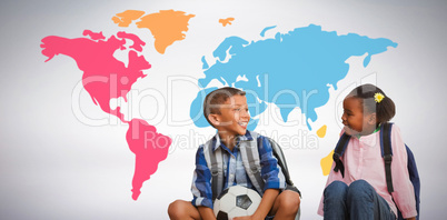 Composite image of boy with friend holding soccer ball