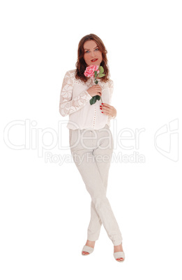 Lovely woman with pink rose standing full body