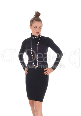 Woman in black dress standing with hands on hip Woman in black dress standing with hands on hip