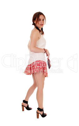 Young lovely woman in shorts looking back