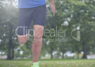 Athletic man's legs running in park