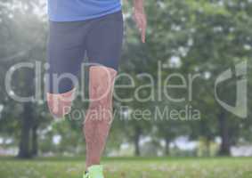 Athletic man's legs running in park