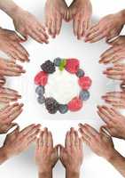 Hands in circle around fruit berries