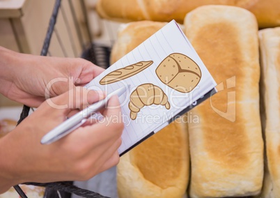 Drawing bread on notepad with bread in background