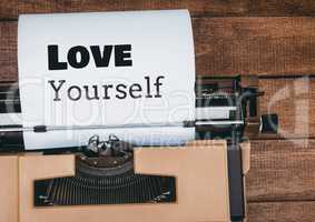 Love Yourself  text written on page with typewriter