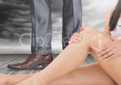 Sexy woman's legs in front of Man in Business attire's legs and shoes with clouds