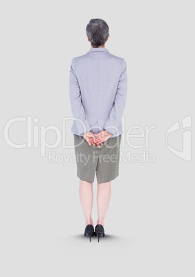 Full body portrait of woman standing with grey background