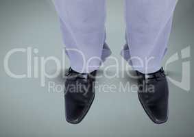 Businessman's feet and shoes on blue background