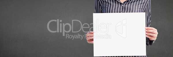 Business woman holding a blank card against grey background