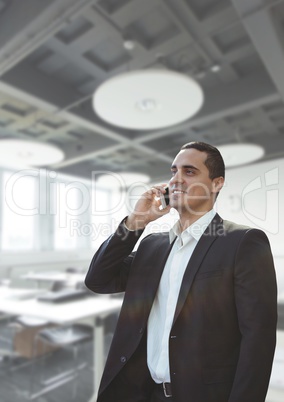 Business man talking on the phone against office background