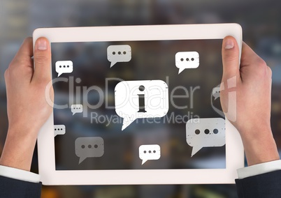 Holding tablet and Information and chat bubbles icons in city