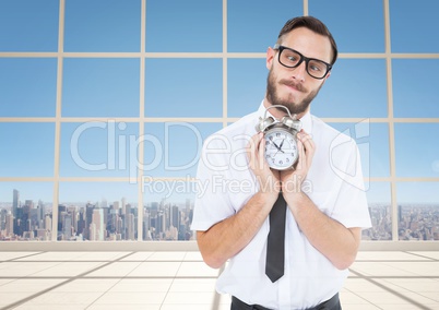 man holding clock in front of windows