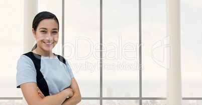 Happy business woman standing against building background