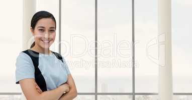 Happy business woman standing against building background