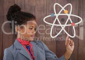 Office kid girl pointing at a science icon against wood wall background