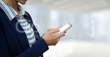 Business woman using a phone against white and blue blurred background