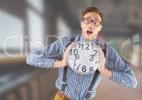 man holding clock in front of blurred background