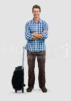 Full body portrait of Man standing with grey background and suitcase