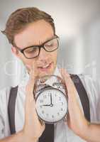 man holding clock in front of blurred bright background
