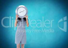 Woman holding clock in front of blue background