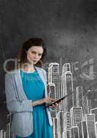 Business woman using a tablet against grey background with city icons