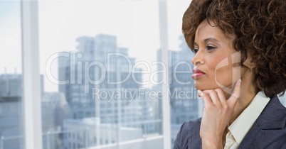 Business woman thinking against city background