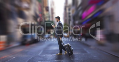 Business man using a phone and holding a suitcase against city background