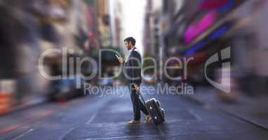 Business man using a phone and holding a suitcase against city background
