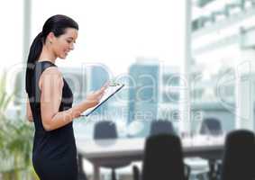 Happy business woman using a phone against office background