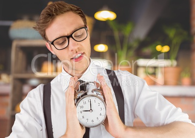 man holding clock in front of cafe