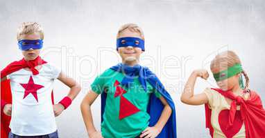 Superhero kids with blank grey wall