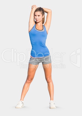 Full body portrait of athletic slim woman standing with grey background